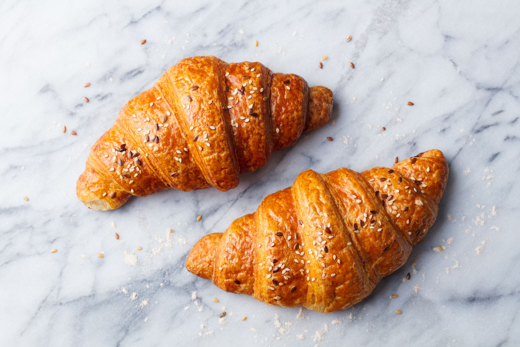 A photo of two croissant across from eachother